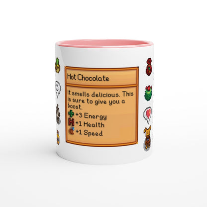 A white mug with a pink rim features a Stardew Drinks pattern depicting a hot chocolate beverage card with stats and sprites.