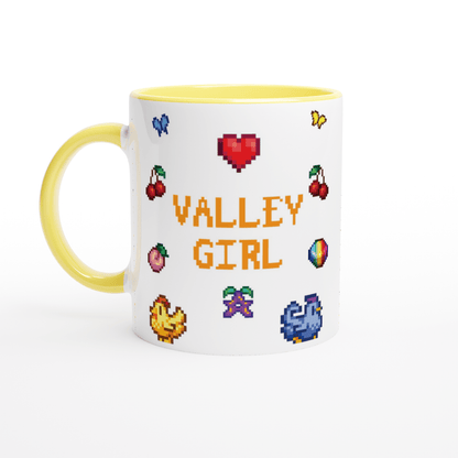 A white coffee mug with a yellow handle features pixel art icons from Stardew Valley including chickens, cherries, a heart, and the words "Valley Girl.
