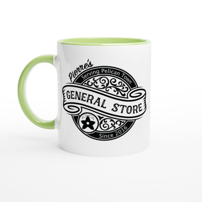 A white ceramic mug features a green handle and rim, displaying a vintage-style logo for Pierre's General Store in Pelican Town from Stardew Valley.