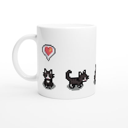 A white mug displays pixelated graphics of tuxedo cats and a heart emote referencing the Stardew Valley computer game.
