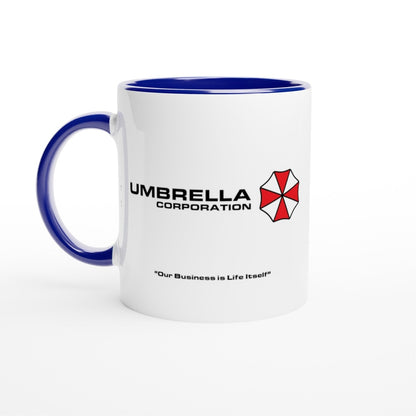 A white mug displays the Umbrella Corporation logo and text referencing "Our Business is Life Itself" from the Resident Evil franchise.