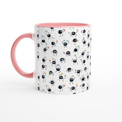 A white ceramic mug with a pink handle and rim features a repeating pattern of black Susuwatari, also known as dust sprites from Spirited Away.