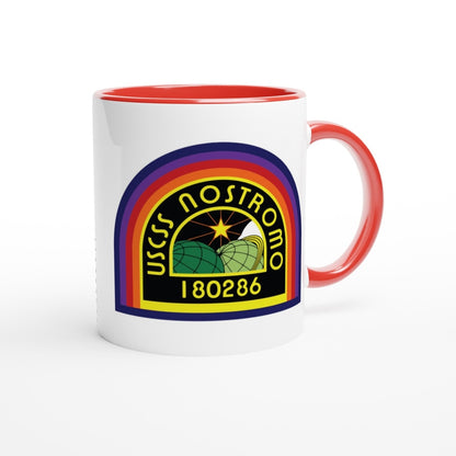 A white ceramic mug features a rainbow-colored logo displaying "USCSS Nostromo" and the number "180286," referencing the Alien movie universe.