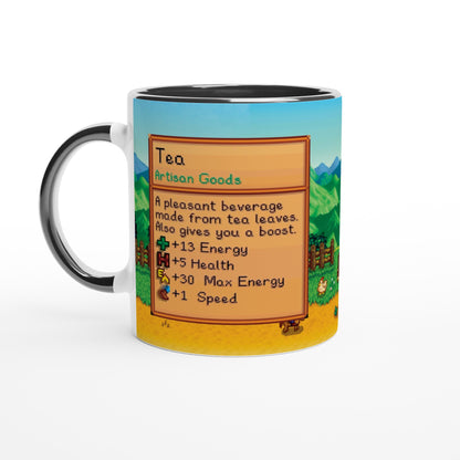This Stardew custom tea mug features a black handle and a background depicting an item card from the game showing details about "Tea" artisan goods.