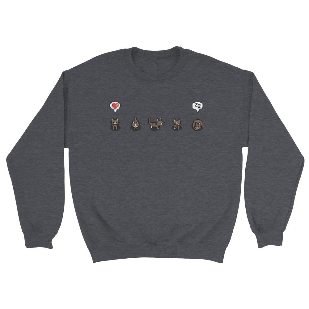 A grey Stardew Valley jumper displays a row of pixelated cat illustrations and emotes across the chest.