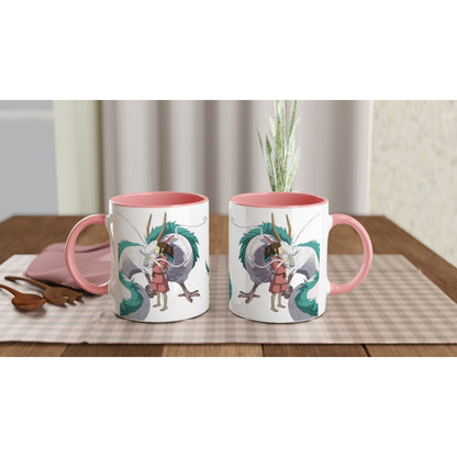 Two white mugs with pink handles depict Haku as a dragon and Chihiro from Spirited Away, inspired by Studio Ghibli.
