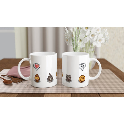 A white mug displays pixelated graphics of ginger and tabby cats alongside emotes from the Stardew Valley computer game.