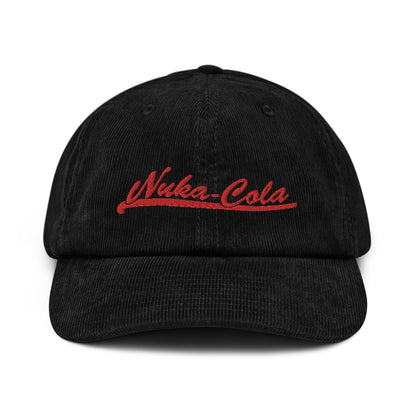 A black corduroy dad hat features red embroidered "Nuka-Cola" lettering across the front panel.