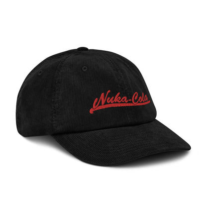 A black Nuka Cola embroidered dad hat features red lettering on the front panel.