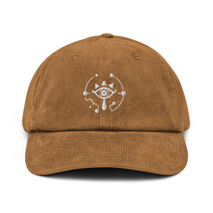 A brown corduroy dad hat features an embroidered Sheikah eye design inspired by The Legend of Zelda: Tears of the Kingdom.