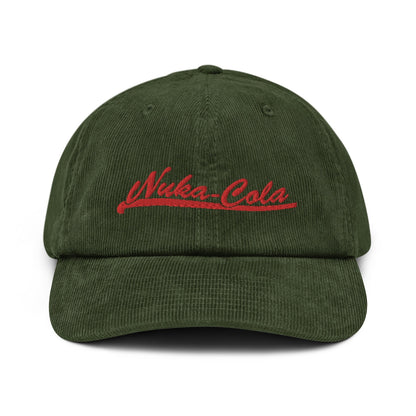 A dark green corduroy dad hat features red embroidered "Nuka-Cola" lettering across the front panel.