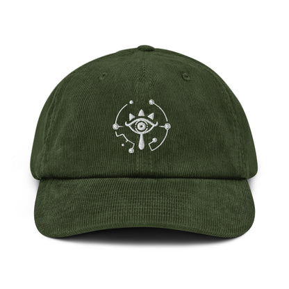 A dark green Zelda Sheikah embroidered cap features a white eye symbol design on the front.