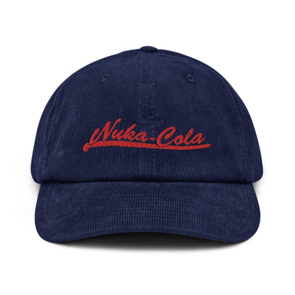 A navy blue corduroy dad hat features red embroidered "Nuka-Cola" lettering on the front panel.