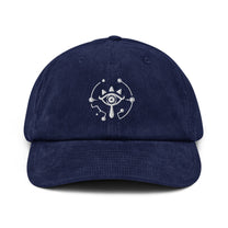 A navy blue corduroy dad hat features an embroidered Sheikah eye symbol from The Legend of Zelda: Tears of the Kingdom.