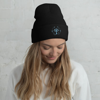 A person wearing a black Zelda Sheikah embroidered beanie featuring a glow-in-the-dark design inspired by Tears of the Kingdom.