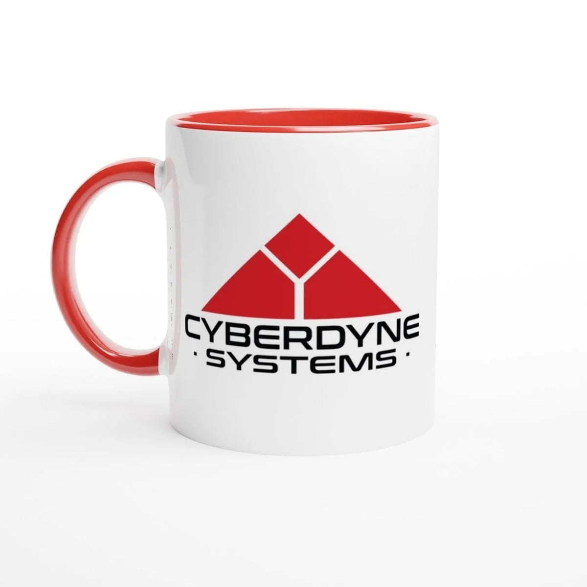 A white ceramic mug displays the Cyberdyne Systems logo from Terminator 2, featuring a red geometric design and company name in black lettering.