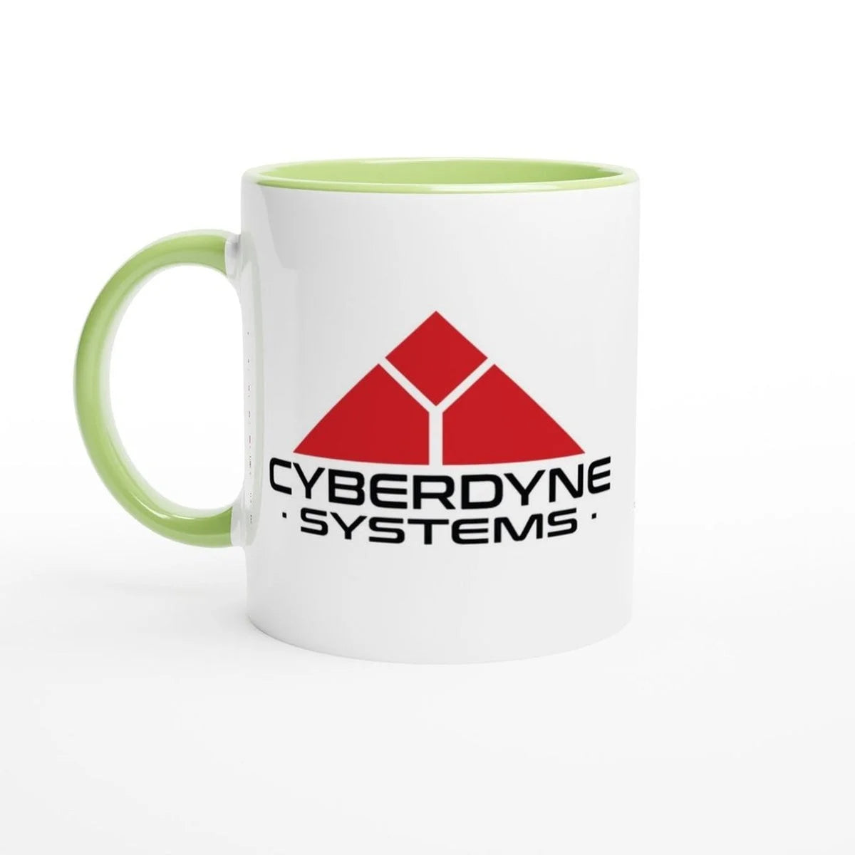 A white ceramic mug displays the Cyberdyne Systems logo from Terminator 2, featuring a red geometric design and company name in green lettering.