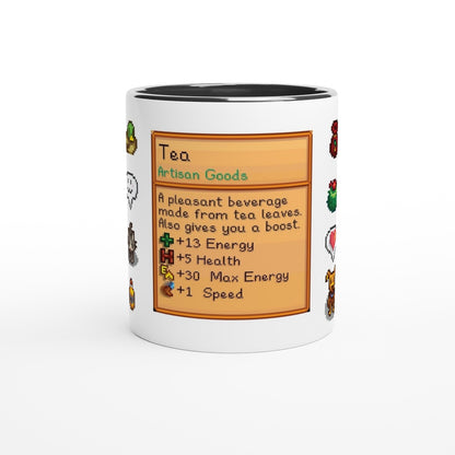 A white mug displays a Stardew Drinks pattern featuring colourful sprites and a beverage card detailing tea's benefits like energy and health.