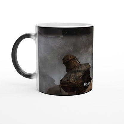 This is a white mug featuring an illustration of a Skyrim character wearing armor and displaying "Hey you" text, referencing the Elder Scrolls game.