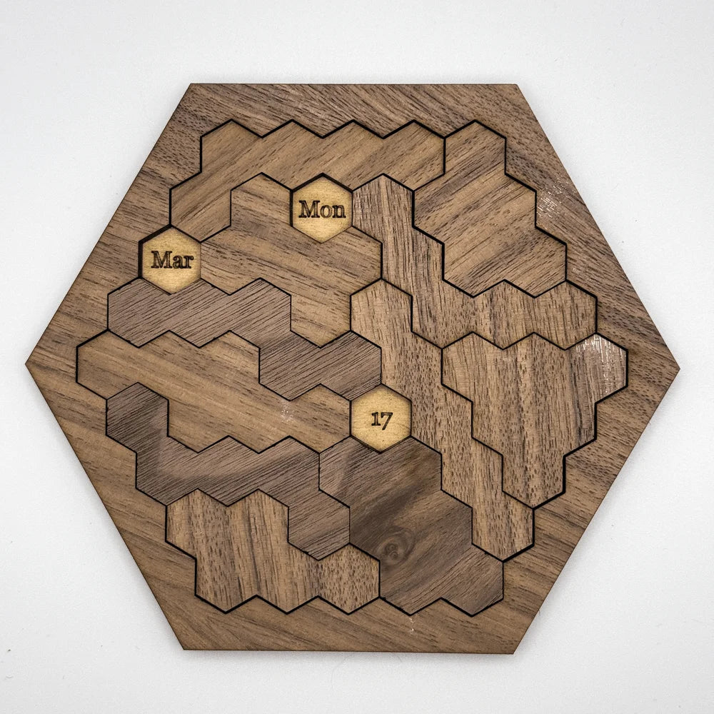 This wooden hexomino puzzle, inspired by Star Trek, displays the dates "Mar," "Mon," and "17" on rotating sections.