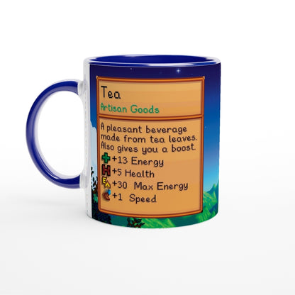 A blue Stardew Custom Farm Mug displays a graphic of tea artisan goods with details about its energy and health benefits.