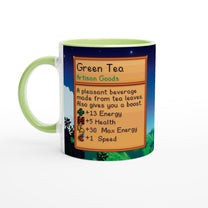 A white ceramic mug featuring pixel art from Stardew Valley that displays a description of Green Tea as an artisan good providing energy, health, and speed boosts.