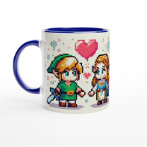 A white mug features a chibi pixel art design of Link and Zelda from The Legend of Zelda standing together with a heart above them, accented by a blue handle and rim.