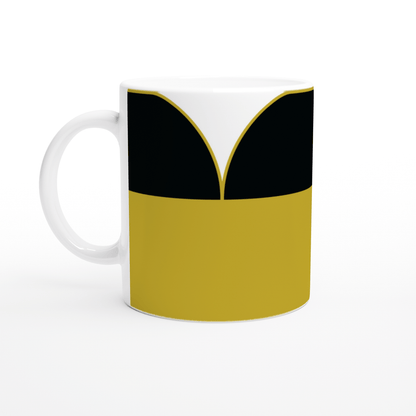 A white mug displays a design inspired by a Star Trek TNG uniform, featuring yellow, black, and white panels.