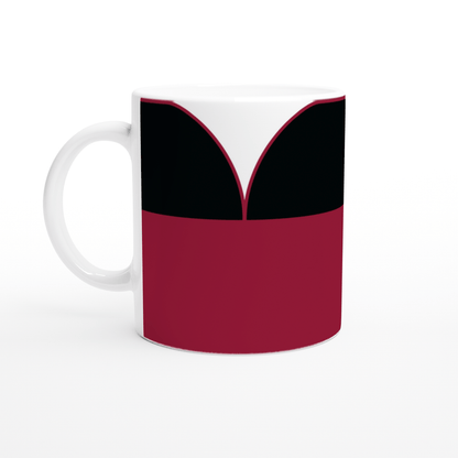 A white mug displays a graphic resembling a Star Trek TNG uniform design featuring red and black panels.
