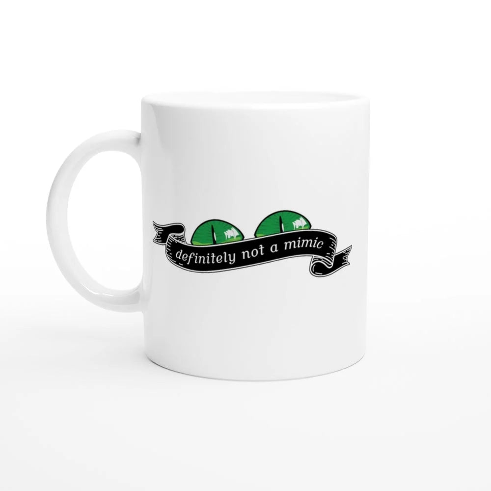 A white mug displays a green D&D mimic face peeking out from behind a banner that reads "definitely not a mimic.