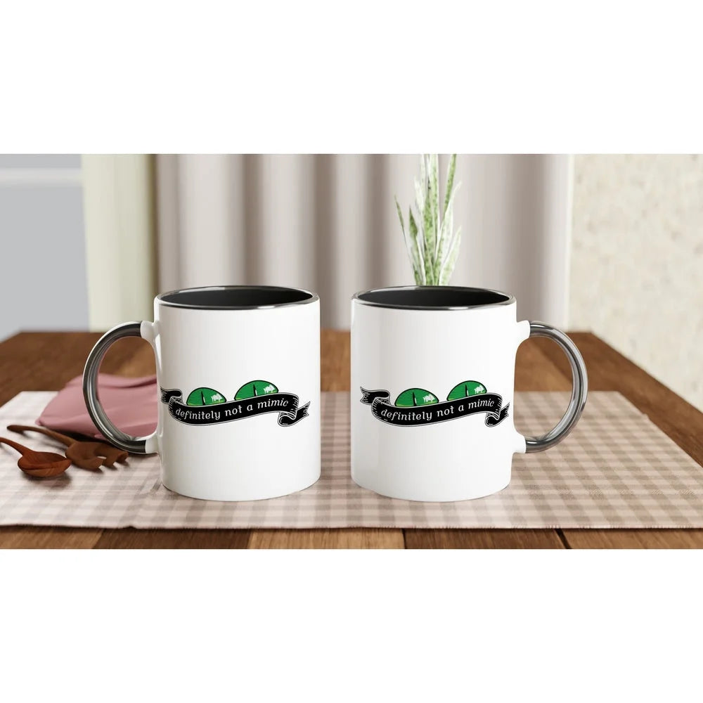 Two white D&D mugs with black interiors and handles display a graphic reading "Definitely Not A Mimic.