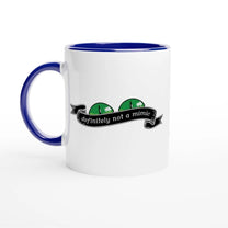 A white mug with a blue handle and rim features a cartoonish green mimic monster design and the words "definitely not a mimic" in a banner.