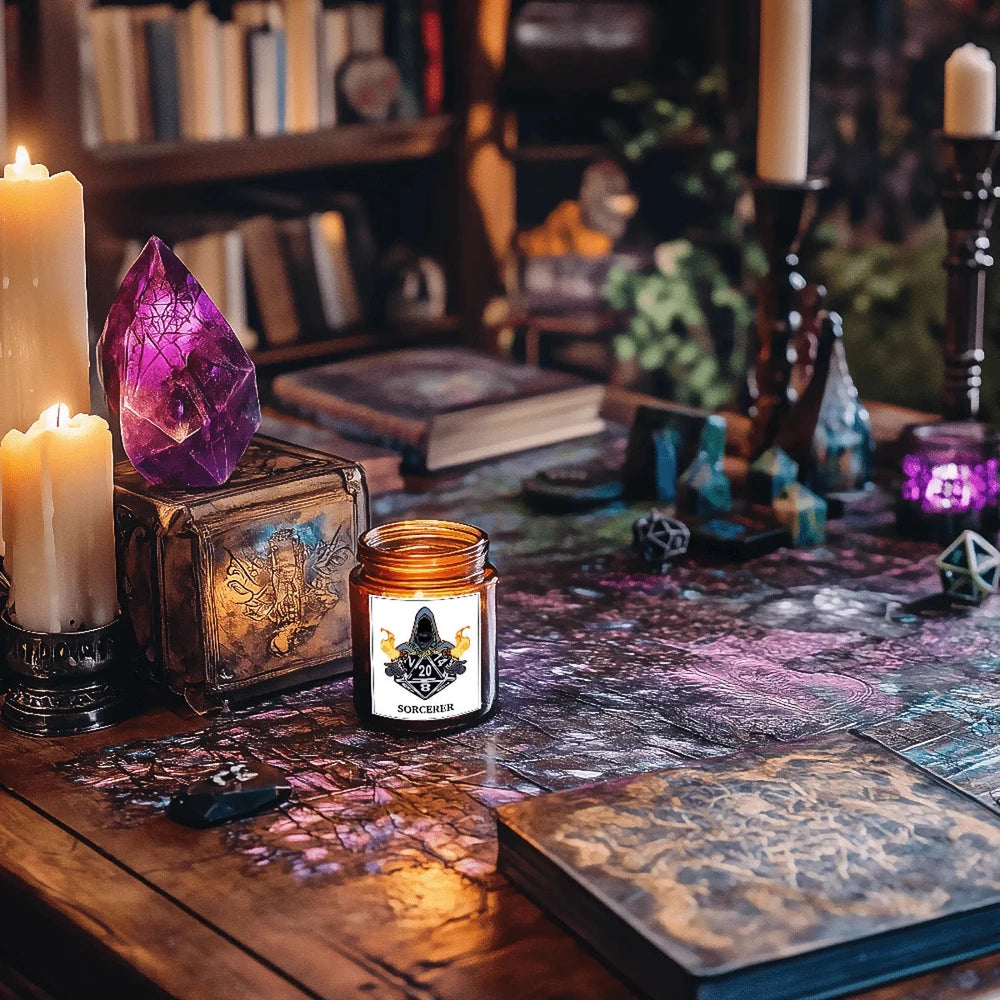 A DnD scented candle labeled "Sorcerer" sits on a wooden tabletop surrounded by books, dice, and candles in a dimly lit setting.