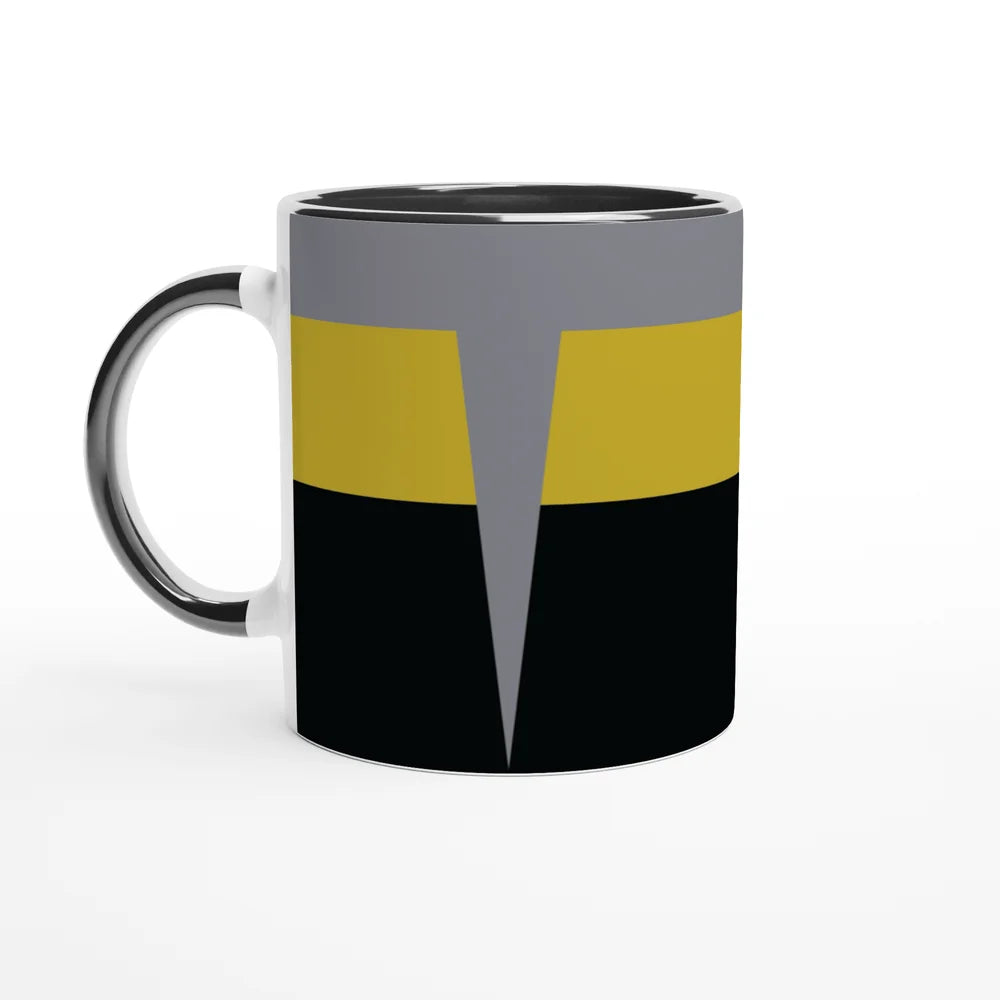 A white mug displays a design inspired by Star Trek Voyager uniforms featuring horizontal bands of black, gold, and gray with a pointed accent.