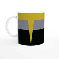 A white mug displays a Star Trek Voyager uniform-inspired design featuring horizontal bands of black, gray, and yellow with a pointed shape in the center.