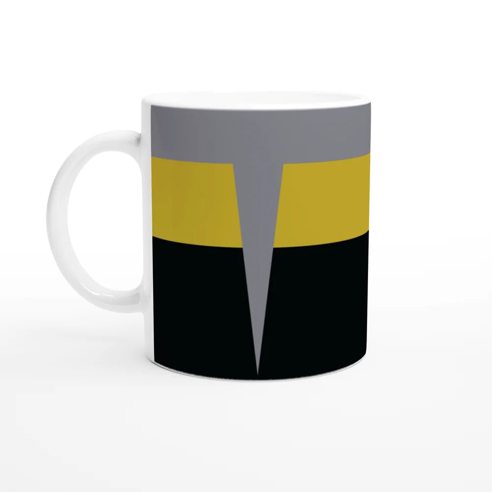 A white mug displays a design inspired by Star Trek DS9 uniforms featuring horizontal bands of gray, yellow, and black.