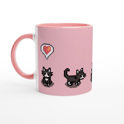 A pink mug displays pixelated graphics of tuxedo cats and a heart emote referencing the Stardew Valley computer game.