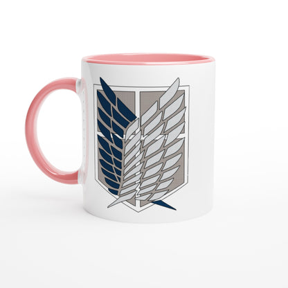 A white ceramic mug with a pink handle and interior features the Wings of Freedom emblem from Attack on Titan.