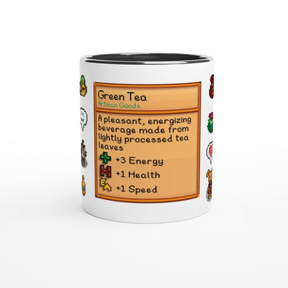 The white Stardew Drinks Pattern Mug displays a colourful beverage card design resembling an item from the video game Stardew Valley, featuring green tea information and stat boosts.