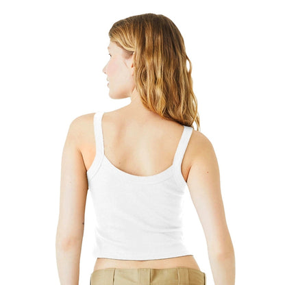 A woman wearing a white Nuka Cola tank top and brown pants is viewed from behind against a plain background.