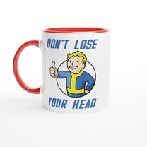 A white mug with a red handle and rim features Vault-Tec branding and cartoon character giving a thumbs up alongside the words "Don't Lose Your Head," referencing the Fallout video game.