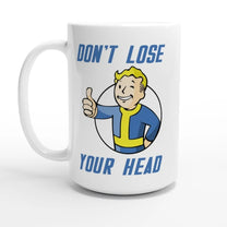 A white mug displays a Vault-Tec mascot giving a thumbs up with the phrase "Don't Lose Your Head" printed above and below.