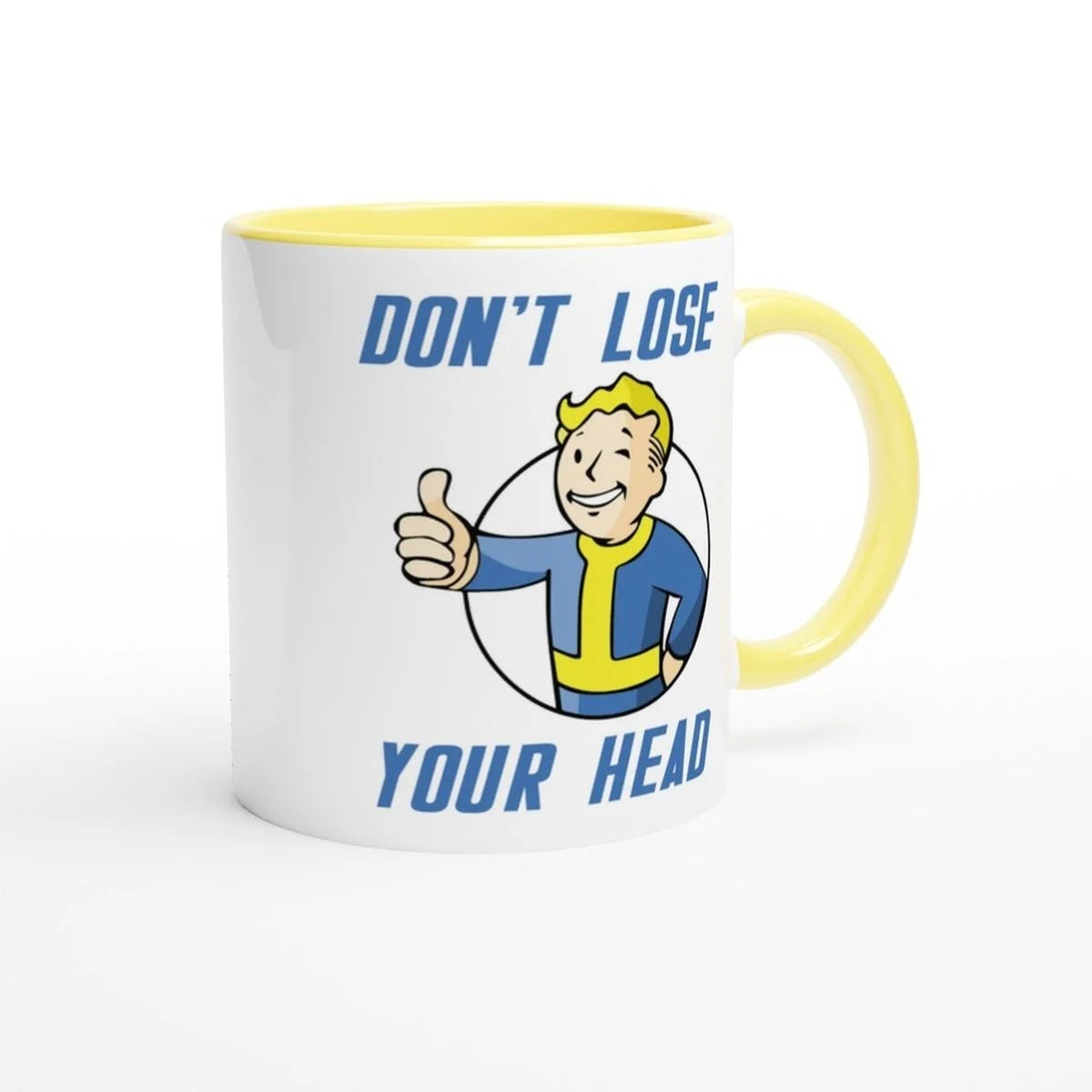 A white mug with a yellow handle and rim features a Vault-Tec mascot giving a thumbs up alongside the words "Don't Lose Your Head" referencing the Fallout video game.