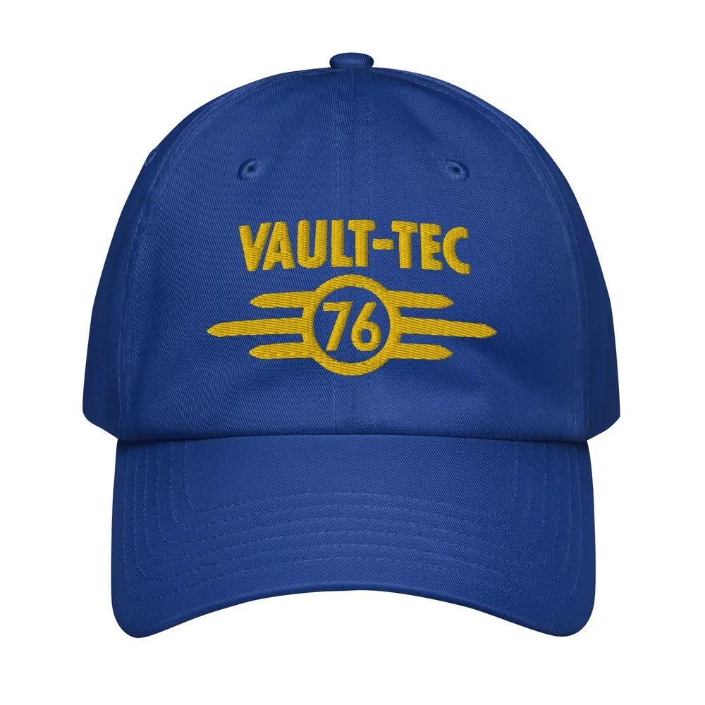 A blue Vault-Tec baseball cap features yellow embroidered lettering and a circular design with the number 76, referencing the Fallout video game series.