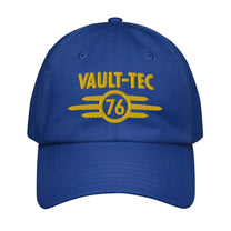 A blue Vault-Tec baseball cap features yellow embroidered lettering and a circular design with the number 76, referencing the Fallout video game series.
