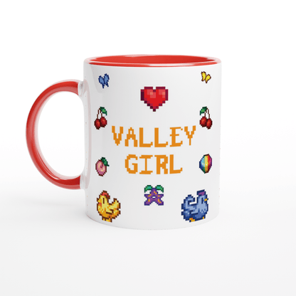 A white coffee mug features pixel art sprites and icons from Stardew Valley including cherries, a heart, chickens, and flowers arranged around the words "Valley Girl".