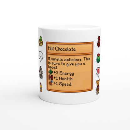 A white mug displays a Stardew Drinks pattern featuring a hot chocolate beverage card with pixelated sprites and stats for energy, health, and speed.
