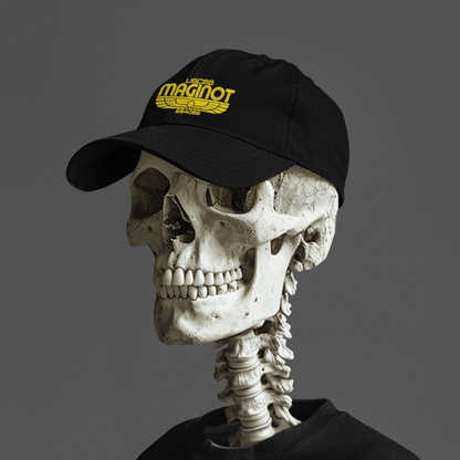 A black baseball cap featuring an embroidered "USCSS Maginot" logo with wings is worn by a human skeleton.