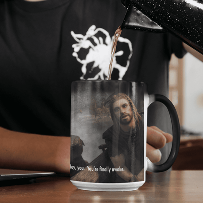 A black Skyrim mug displays a heat-activated image of a character from The Elder Scrolls and the words "Hey You, You're Finally Awake.
