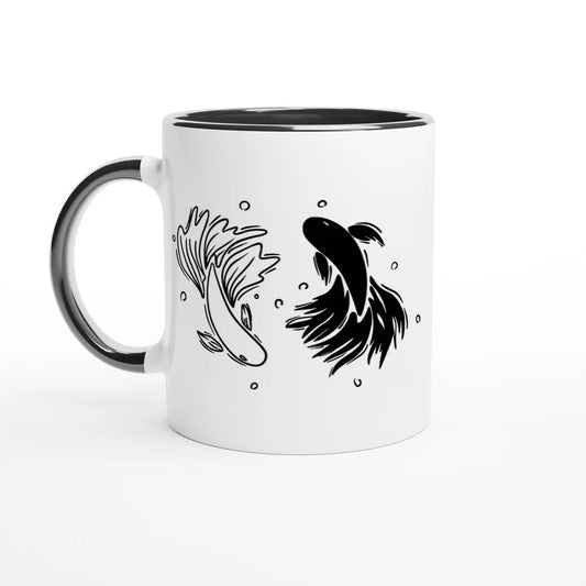 A white mug with a black rim and handle features a black and white illustration of betta fish arranged in a yin yang design.